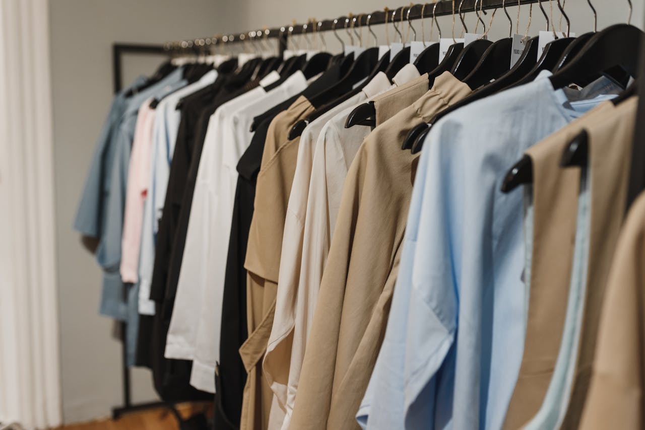 Stylish clothes hanging on a rack, showcasing a variety of elegant fashion pieces.