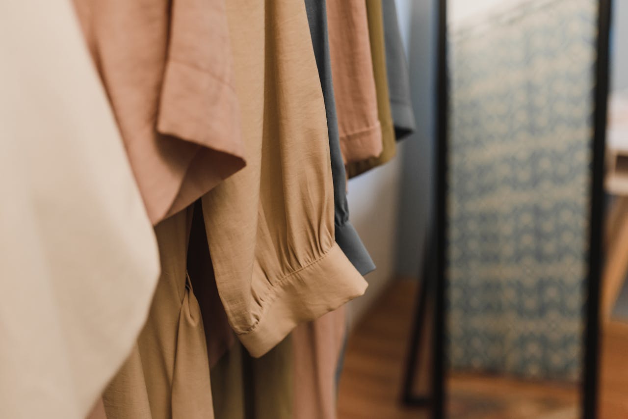 A detailed view of various garments hanging neatly in a clothing wardrobe.